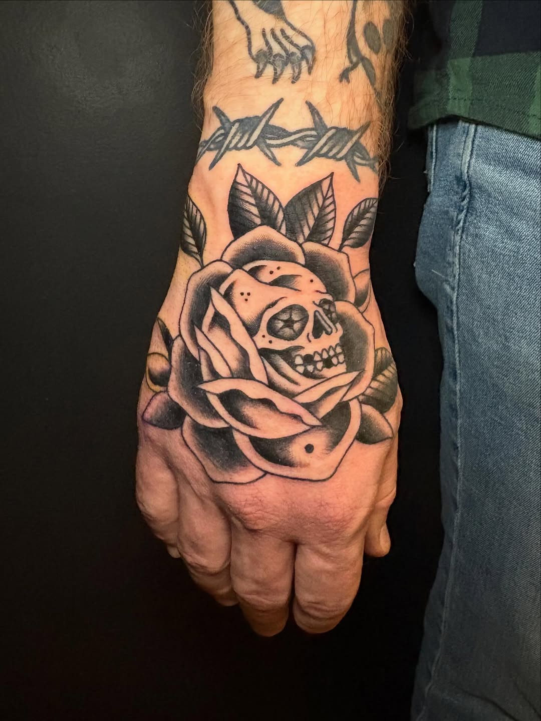 Skull rose hand tattoo by Rikki Kander